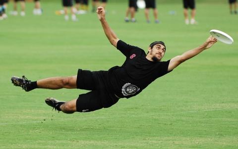 A player laying out fully extended to catch the disc